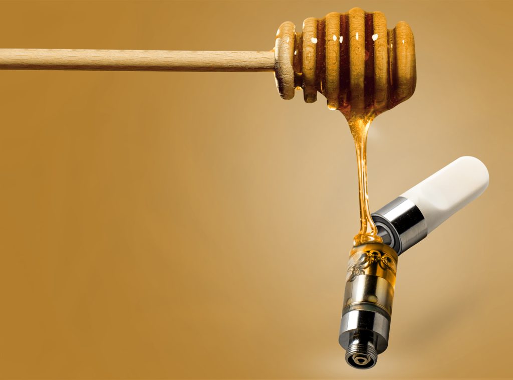 Honey dripping into ceramic vape cartridge